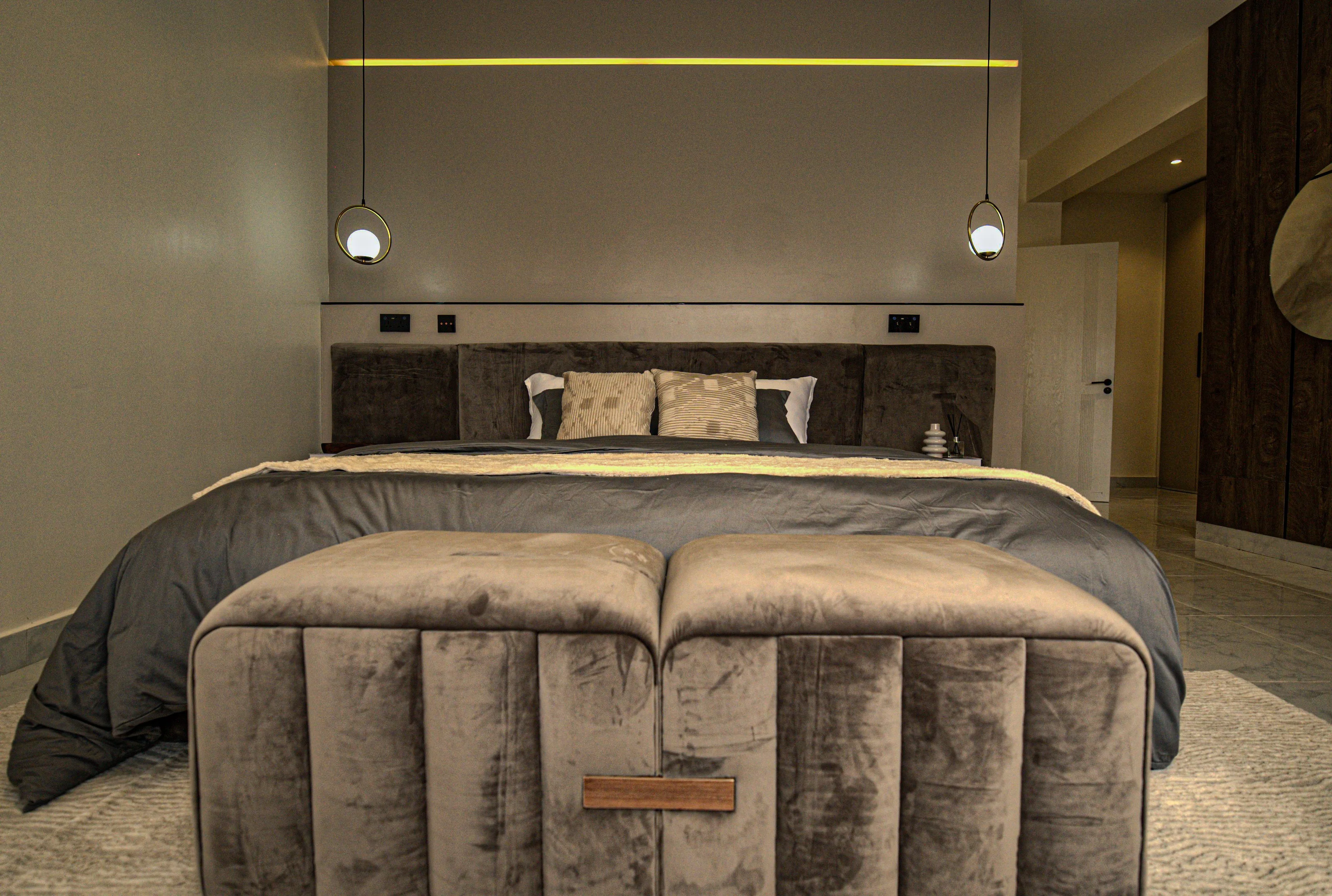 Upholstered bed and matching bench with pendant bedside lighting
